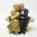 Goldene Hochzeit Figur, Goldpaar auf Sofa.
